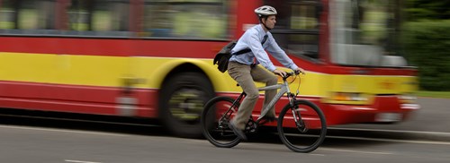 Man On Bike Past Bus (2)